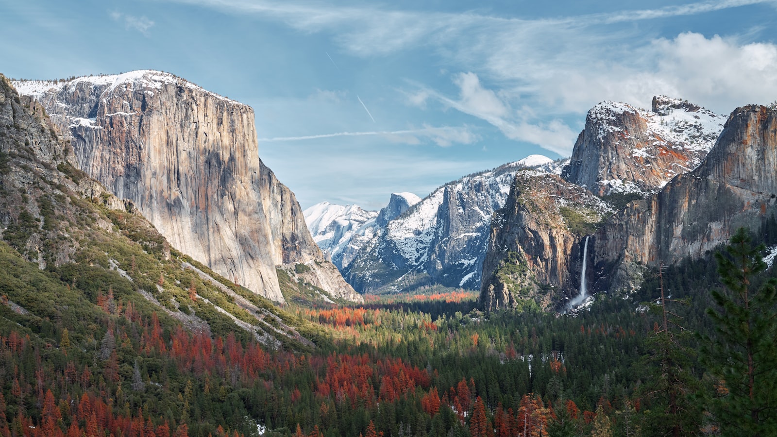 Yosemite Valley from Tunnel View in autumn, El Capitan on the left and Bridalveil Fall on the right, with orange and red trees on the valley floor